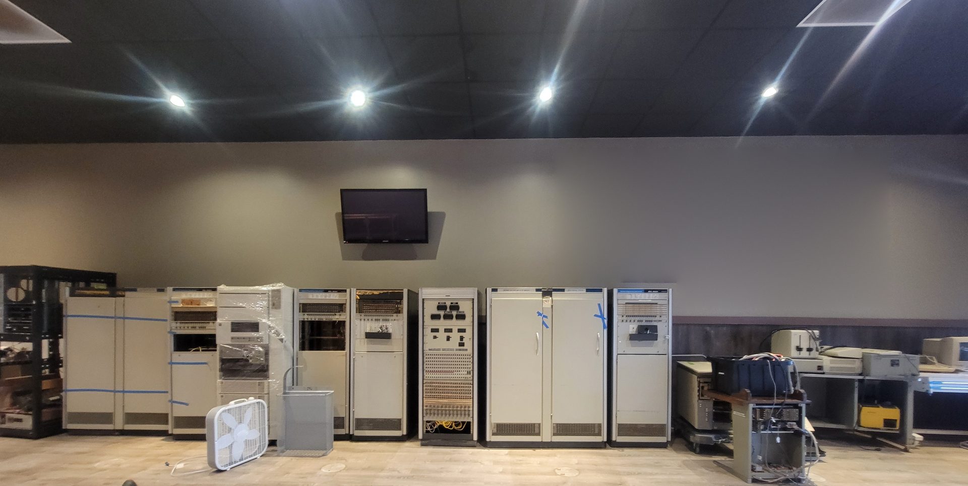 Restoration bay: minicomputer cabinets and tape gear along the shop wall