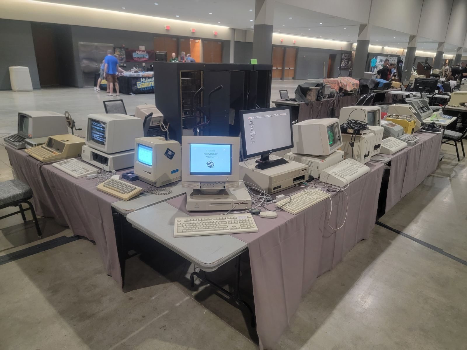 Row of vintage microcomputers running side by side at a show